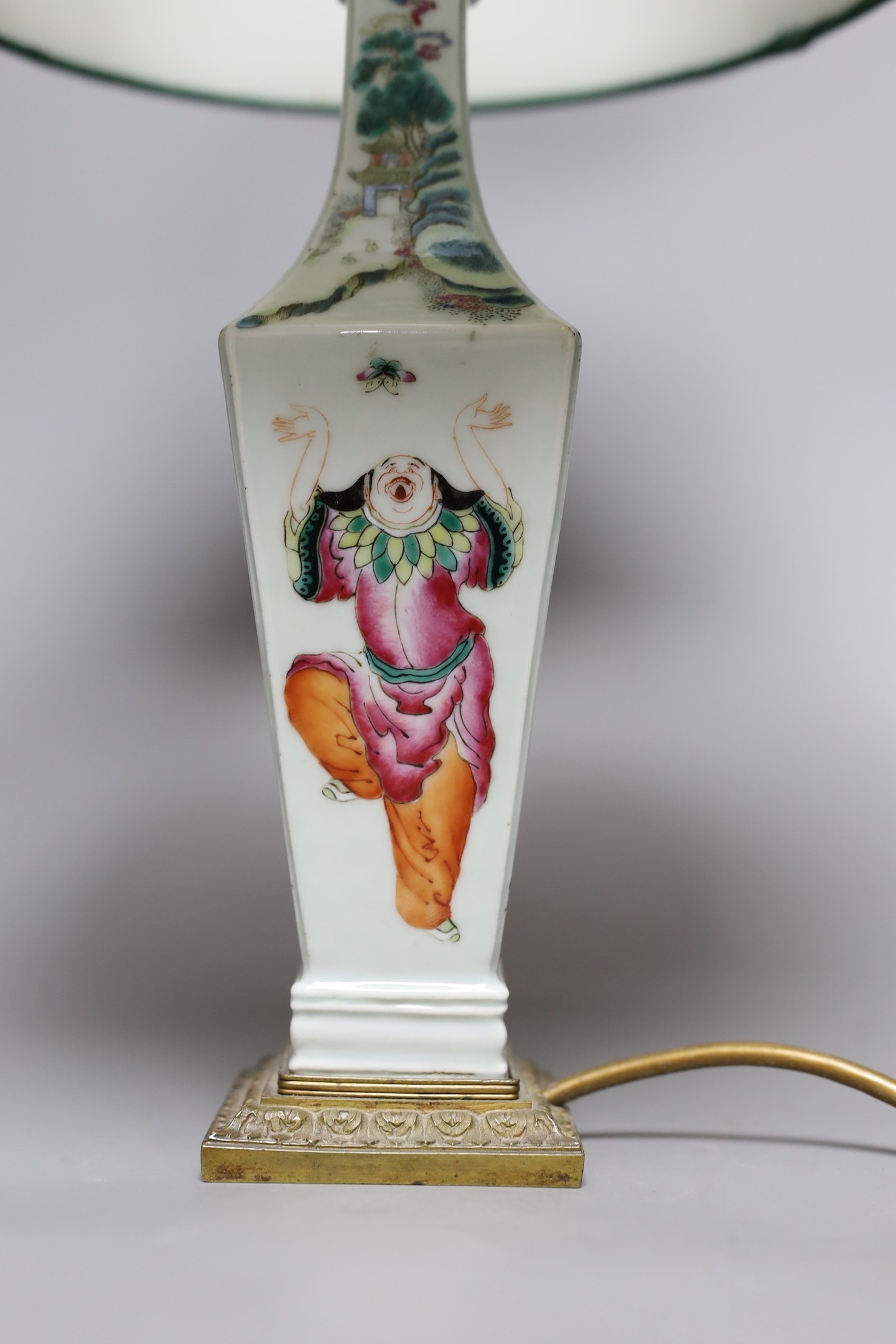 A Chinese famille rose ‘Liu Hai’ vase, late 19th century, with gilt mounts, drilled and converted to a lamp, 28 cms high